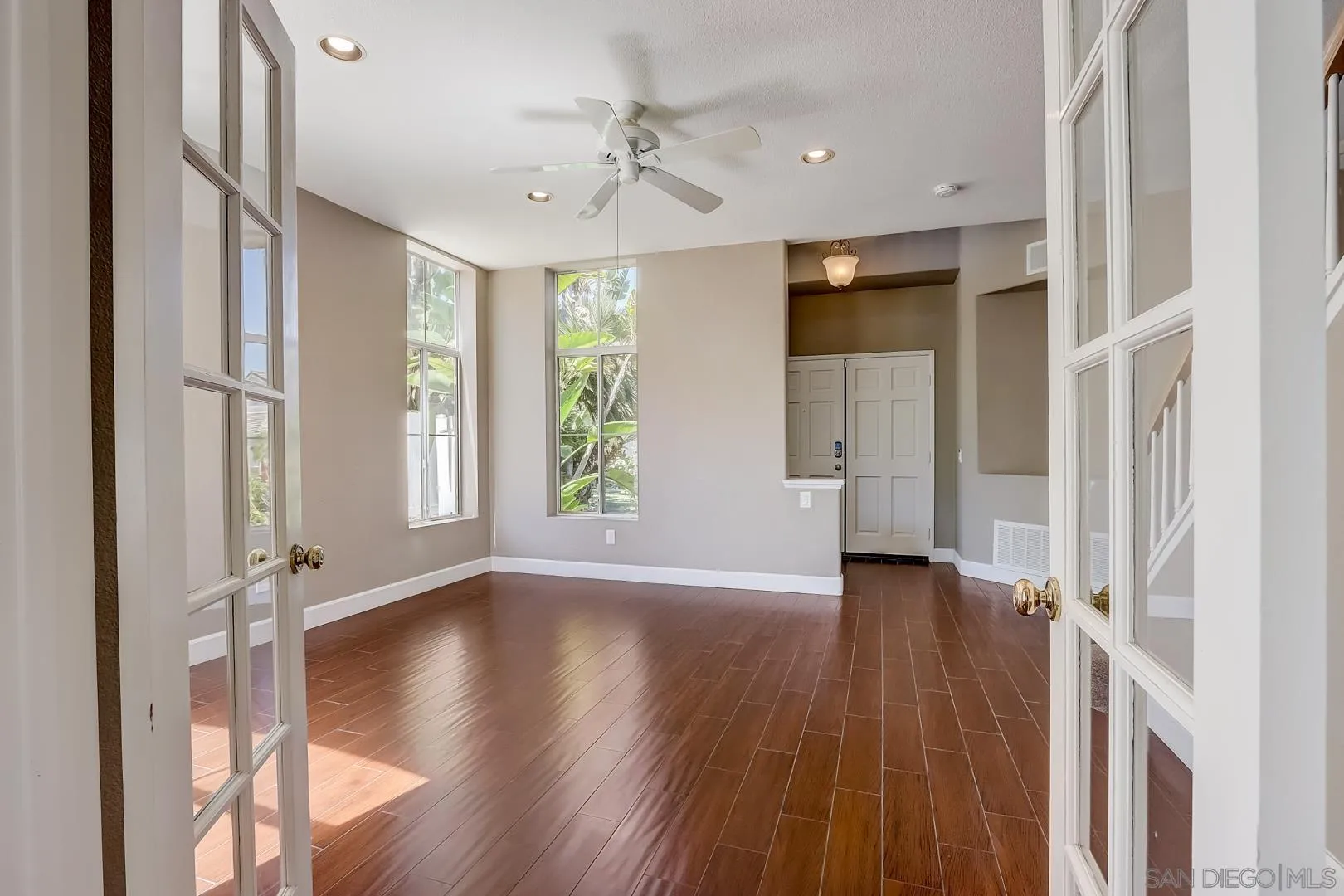 4824 Contour Court Oceanside, CA 92057 - Photo 24 of 32 an empty room with wooden floor and windows
