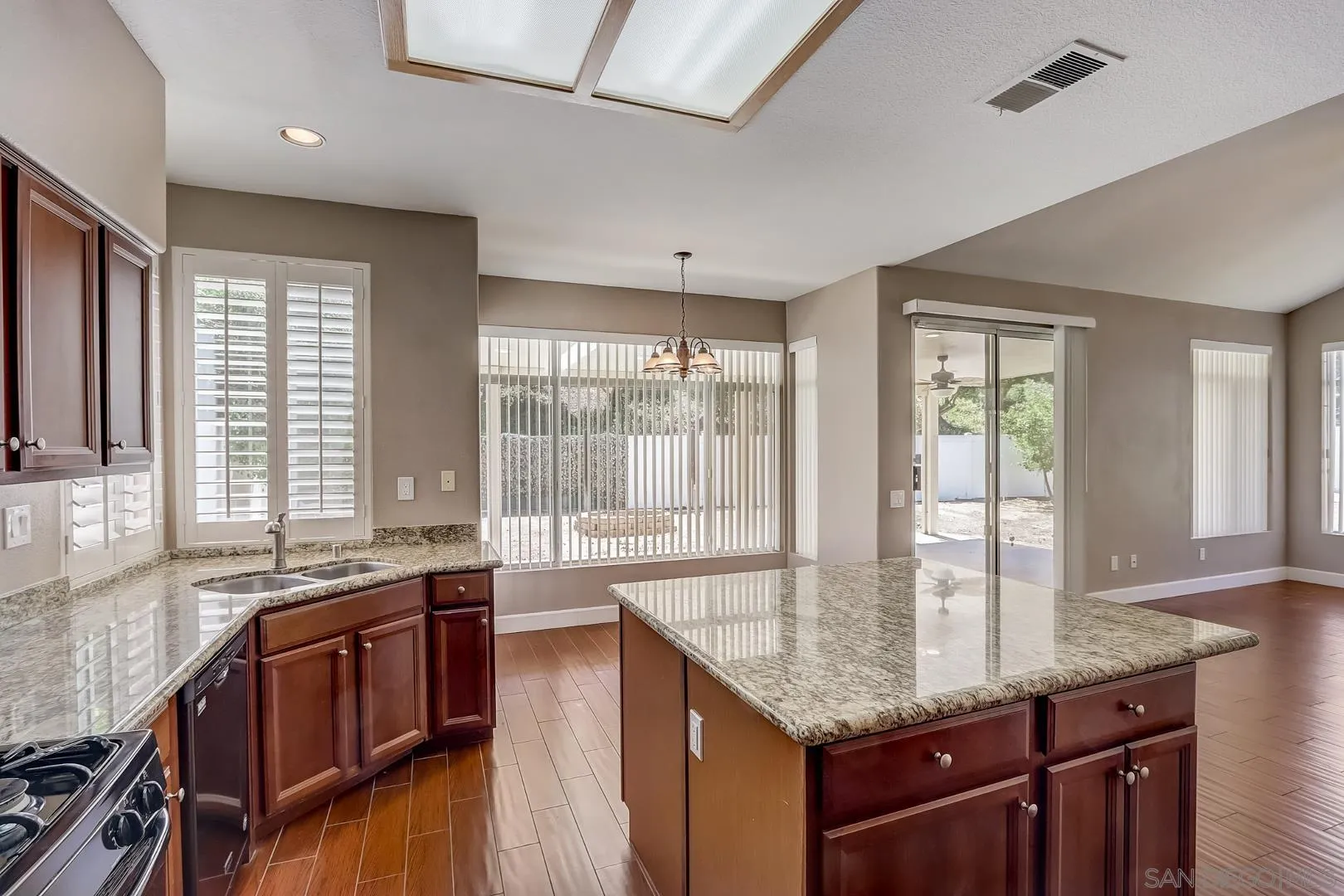 4824 Contour Court Oceanside, CA 92057 - Photo 26 of 32 a kitchen with stainless steel appliances granite countertop a stove a sink and a microwave