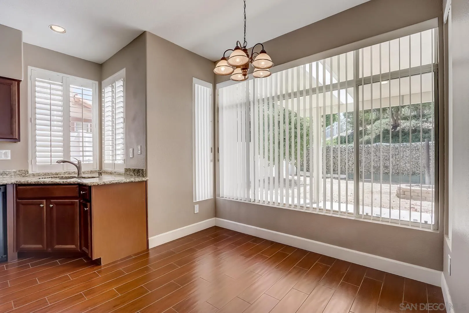 4824 Contour Court Oceanside, CA 92057 - Photo 27 of 32 a view of an empty room with wooden floor and a window