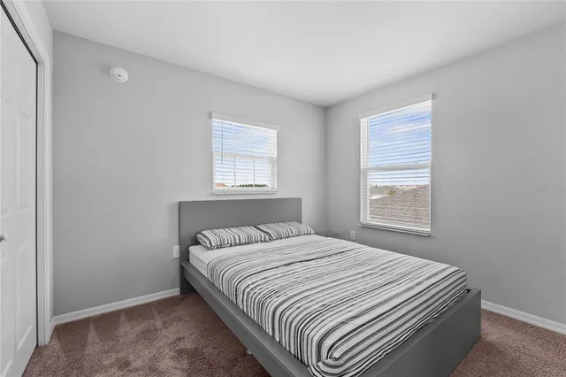 a spacious bathroom with a double vanity sink and a mirror