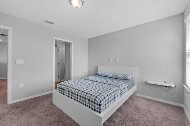 a room with a bed and a large window