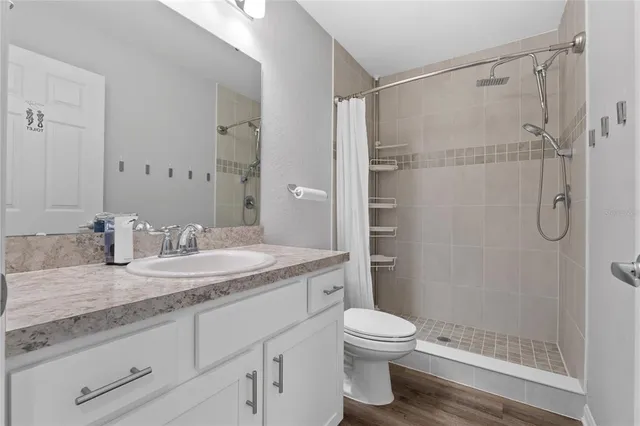 a swimming pool with lawn chairs under an umbrella