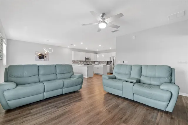 a bathroom with a granite countertop double vanity sink and a mirror