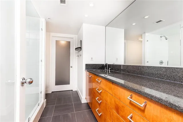 a large bathroom with a tub and shower