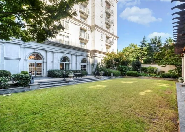 a front view of a house with swimming pool having outdoor seating