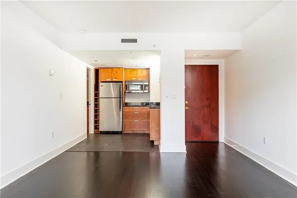 a view of a room with wooden floor and a window