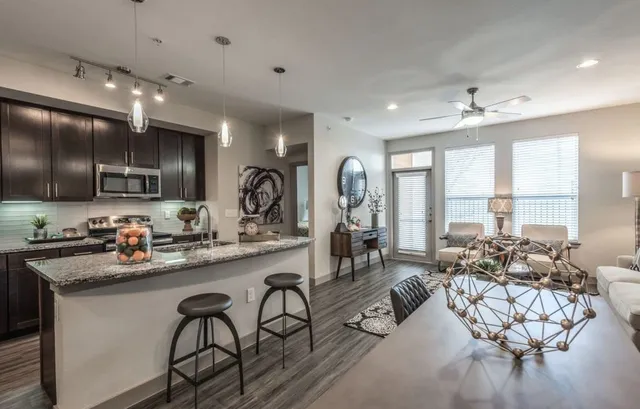 a very nice looking kitchen with a large window appliances and cabinets