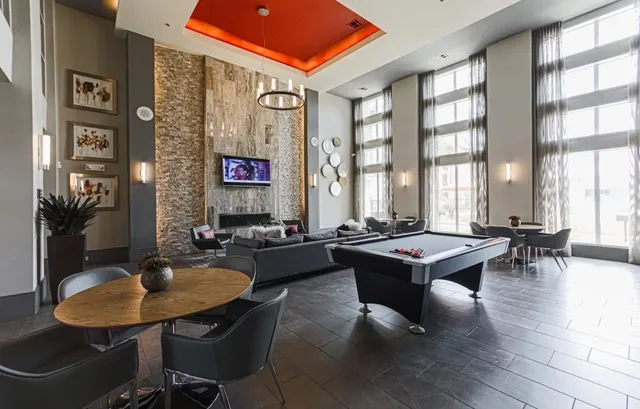 a living room with furniture a rug and a large window