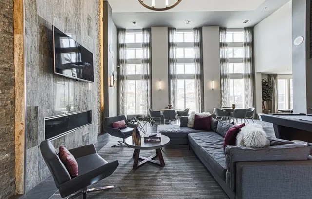 a living room with furniture fireplace and flat screen tv