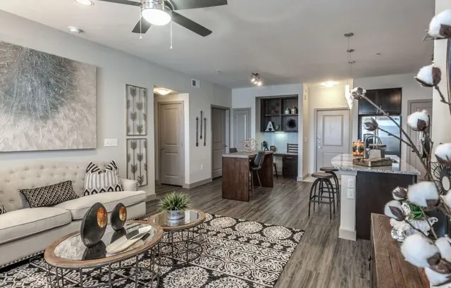 a living room with furniture and a wooden floor