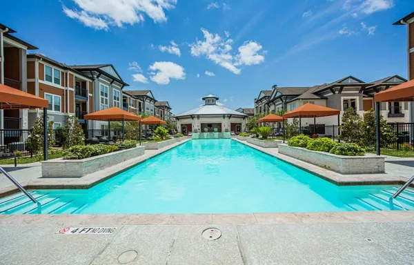a view of a house with a swimming pool and a yard
