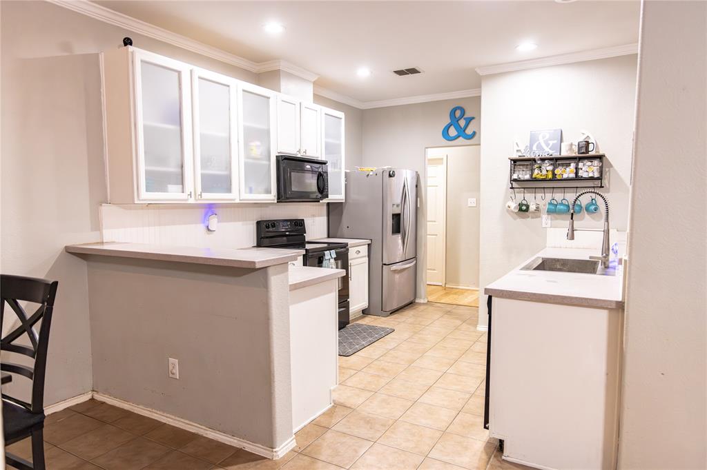 104 South Forest Grove Princeton, TX 75407 - Photo 12 of 36 a kitchen with stainless steel appliances a refrigerator sink and microwave