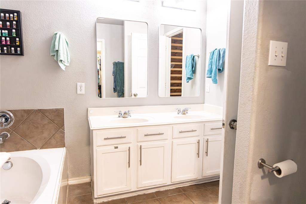 104 South Forest Grove Princeton, TX 75407 - Photo 21 of 36 a bathroom with a sink and a mirror