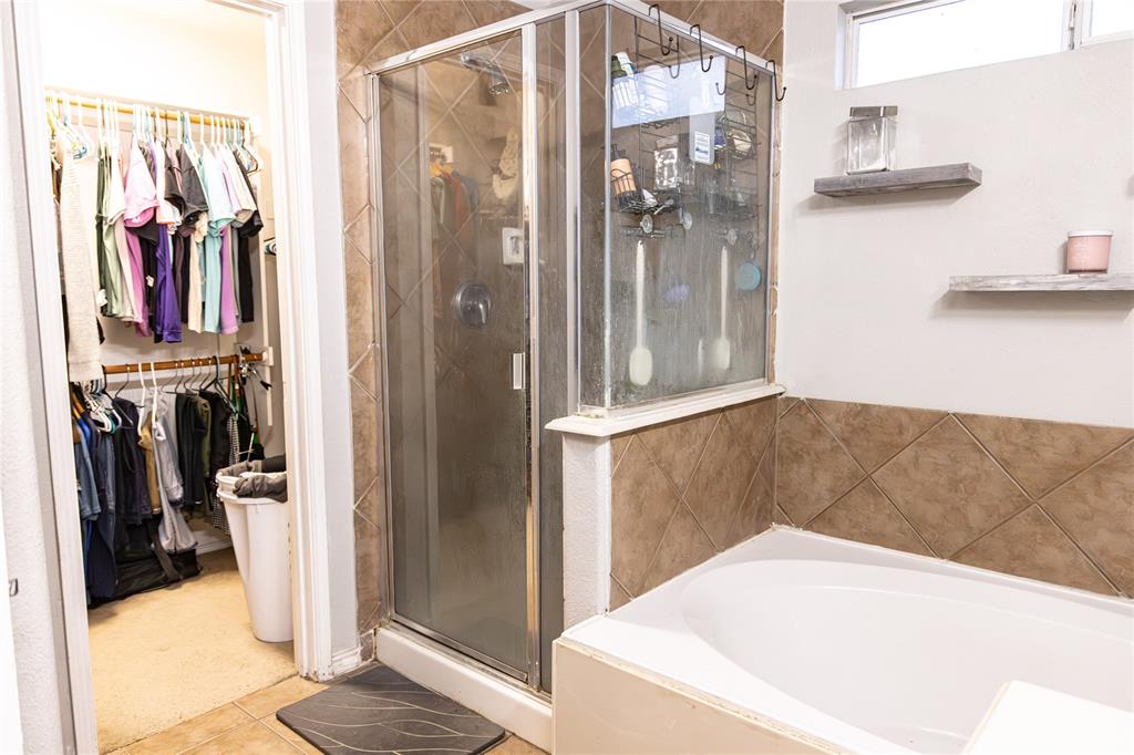 104 South Forest Grove Princeton, TX 75407 - Photo 24 of 36 a view of walk in closet with clothes and shoes