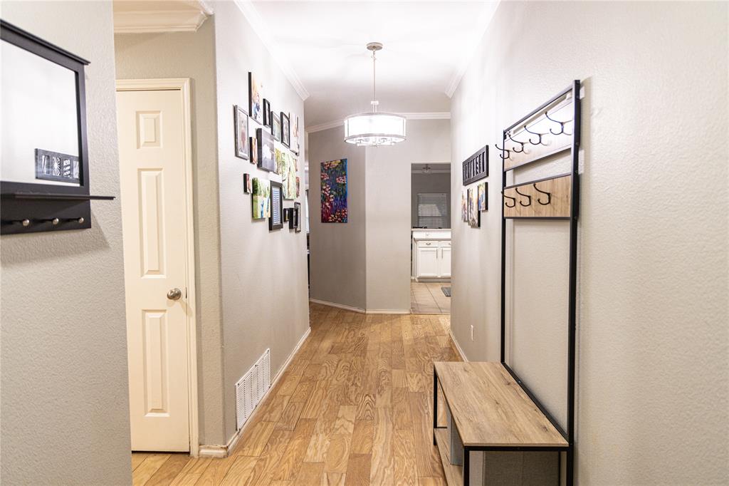 104 South Forest Grove Princeton, TX 75407 - Photo 32 of 36 a view of a hallway view with wooden floor and staircase