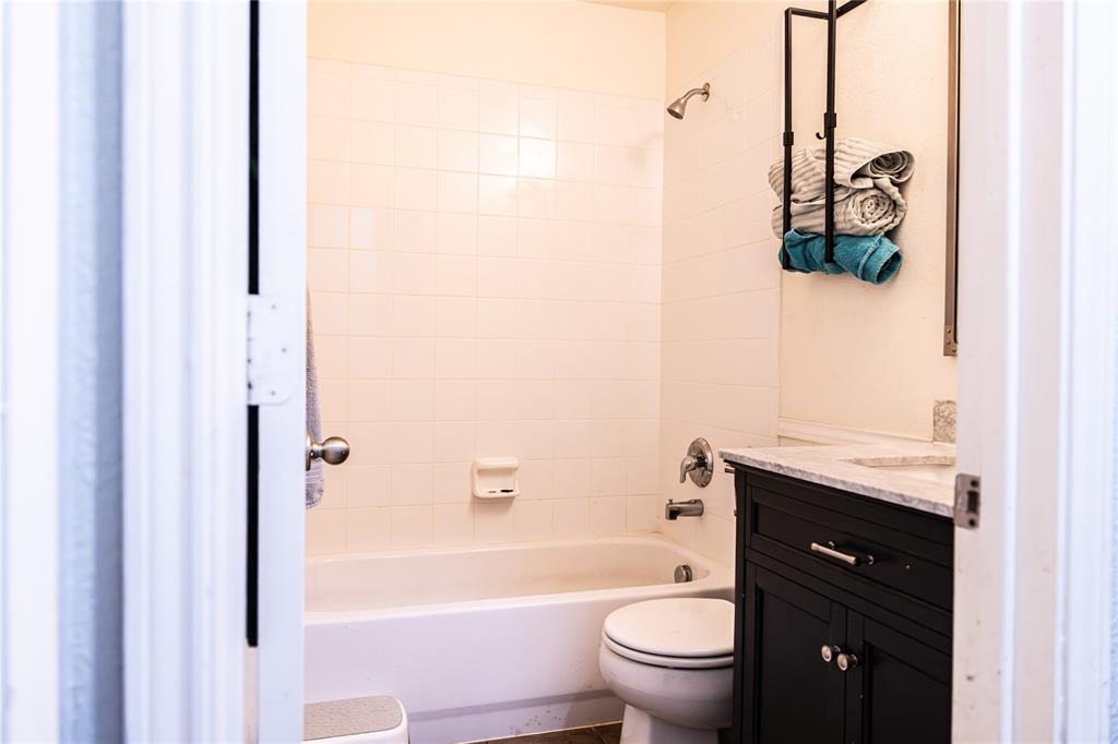 104 South Forest Grove Princeton, TX 75407 - Photo 35 of 36 a bathroom with a granite countertop toilet a sink and a bathtub