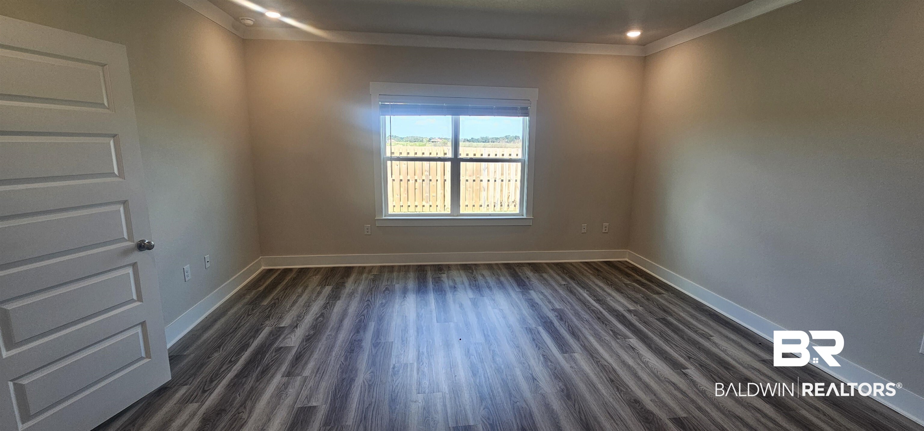 1045 Hayward Loop Foley, AL 36535 - Photo 7 of 12 Unfurnished room featuring dark wood-style flooring, ornamental molding, and recessed lighting