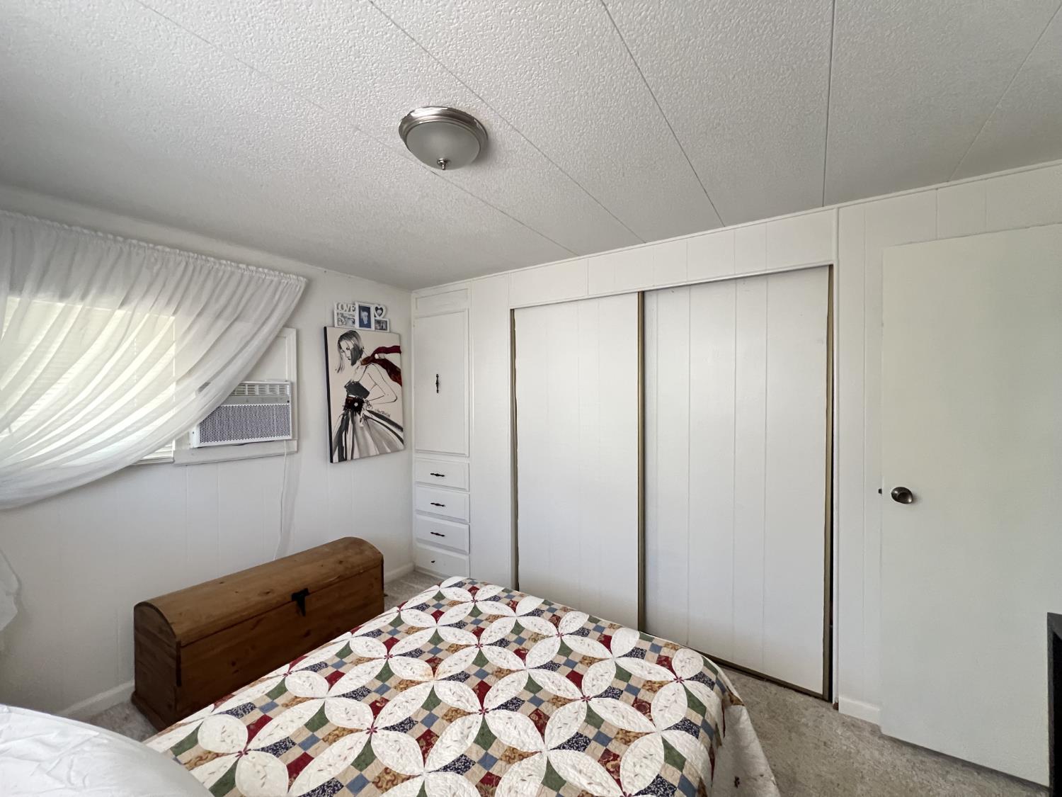 9060 Auburn Folsom Road, Unit 36 Granite Bay, CA 95746 - Photo 11 of 14 a bedroom with a bed and a dresser