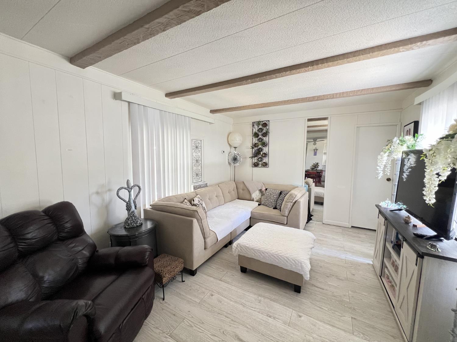 9060 Auburn Folsom Road, Unit 36 Granite Bay, CA 95746 - Photo 3 of 14 a living room with furniture and a flat screen tv