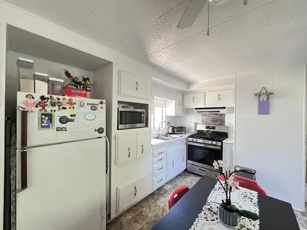 a kitchen with stainless steel appliances a refrigerator sink and cabinets