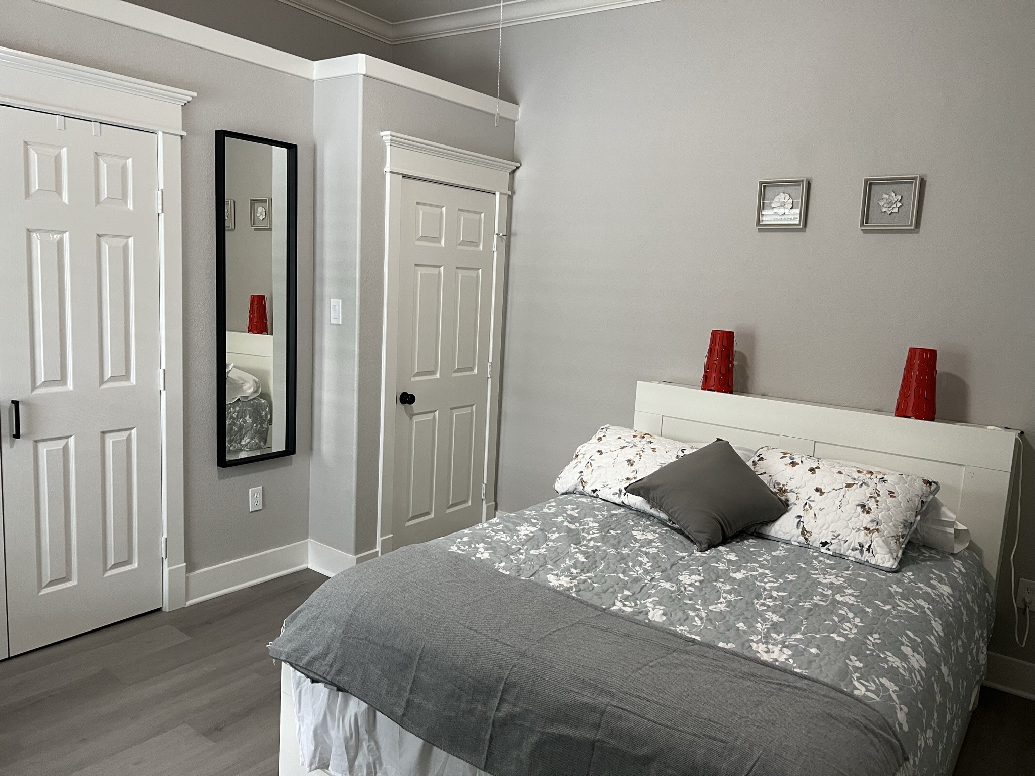 220 Redan Street, Unit A Houston, TX 77009 - Photo 17 of 22 a bedroom with a bed and a wooden floor