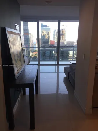 a dining room with furniture and a floor to ceiling window
