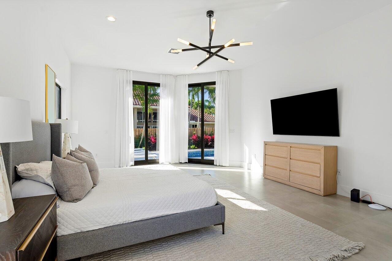 636 Eddy Street Boca Raton, FL 33487 - Photo 27 of 44 a bedroom with a bed and a flat screen tv