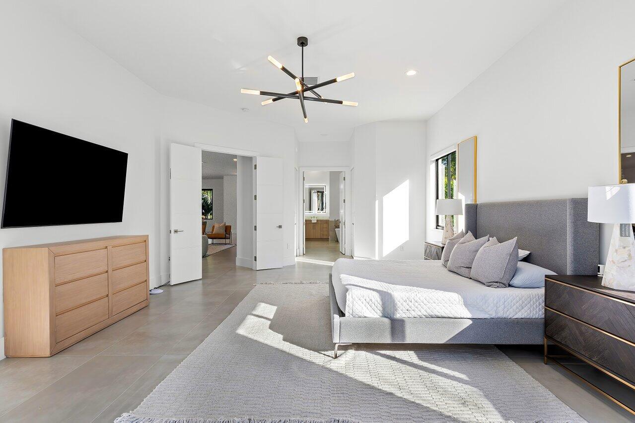 636 Eddy Street Boca Raton, FL 33487 - Photo 28 of 44 a bedroom with a bed and a flat screen tv