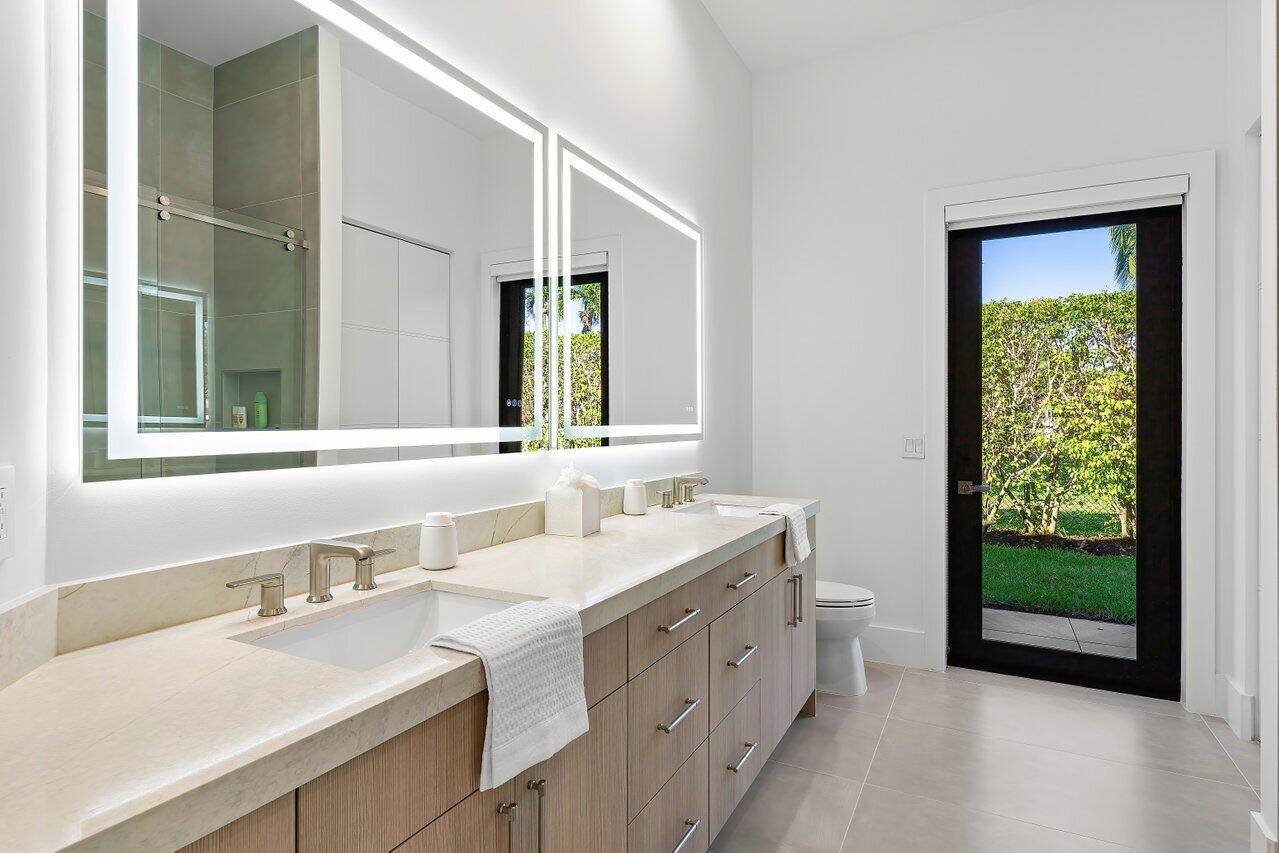 636 Eddy Street Boca Raton, FL 33487 - Photo 33 of 44 a bathroom with a double vanity sink mirror and a bathtub