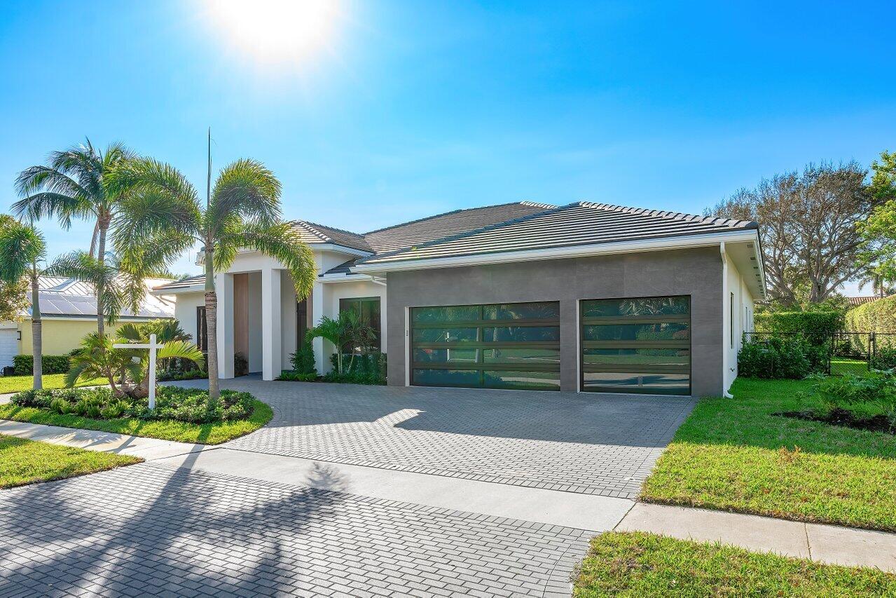 636 Eddy Street Boca Raton, FL 33487 - Photo 4 of 44 a view of a house with a yard and palm trees