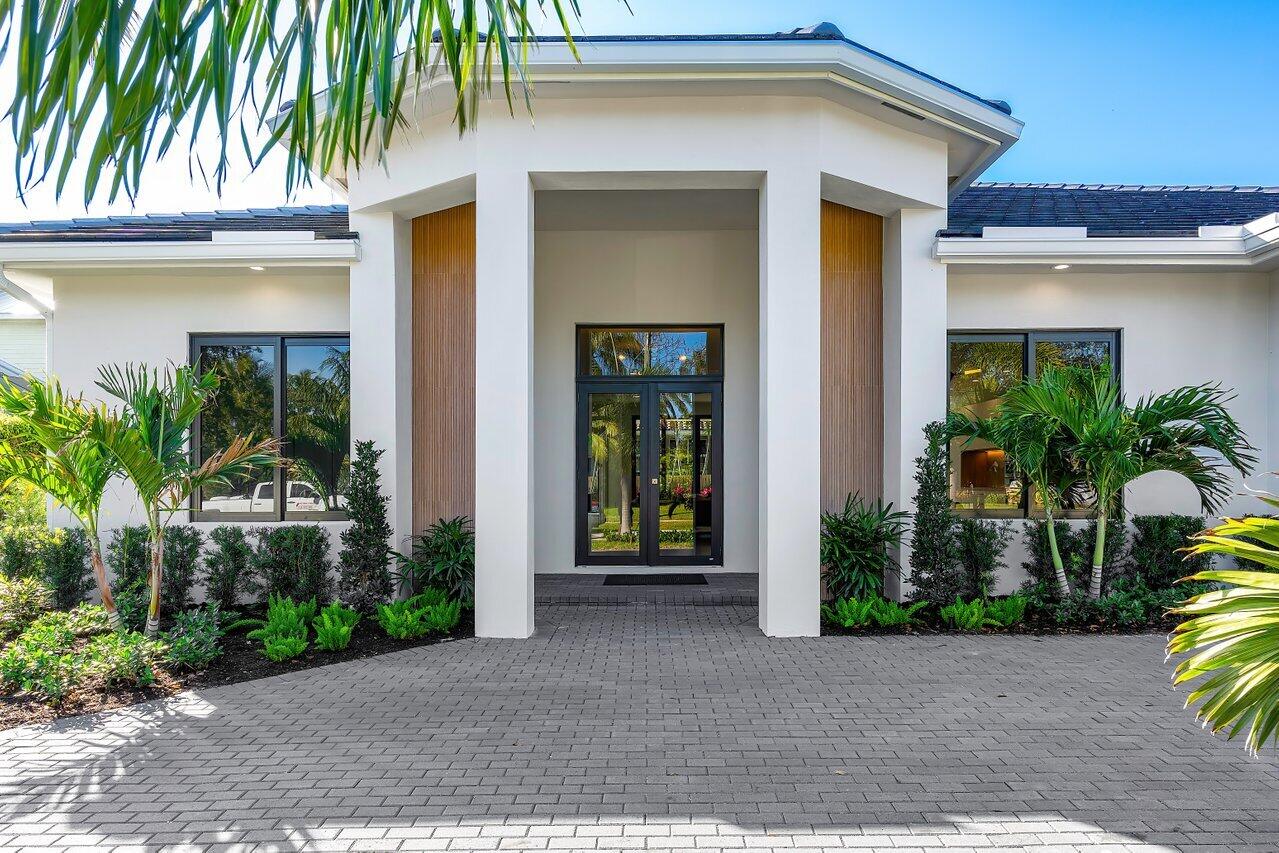 636 Eddy Street Boca Raton, FL 33487 - Photo 6 of 44 a front view of a house with garden