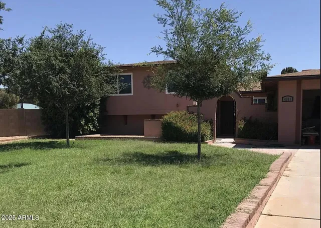 a house view with a sitting space and garden