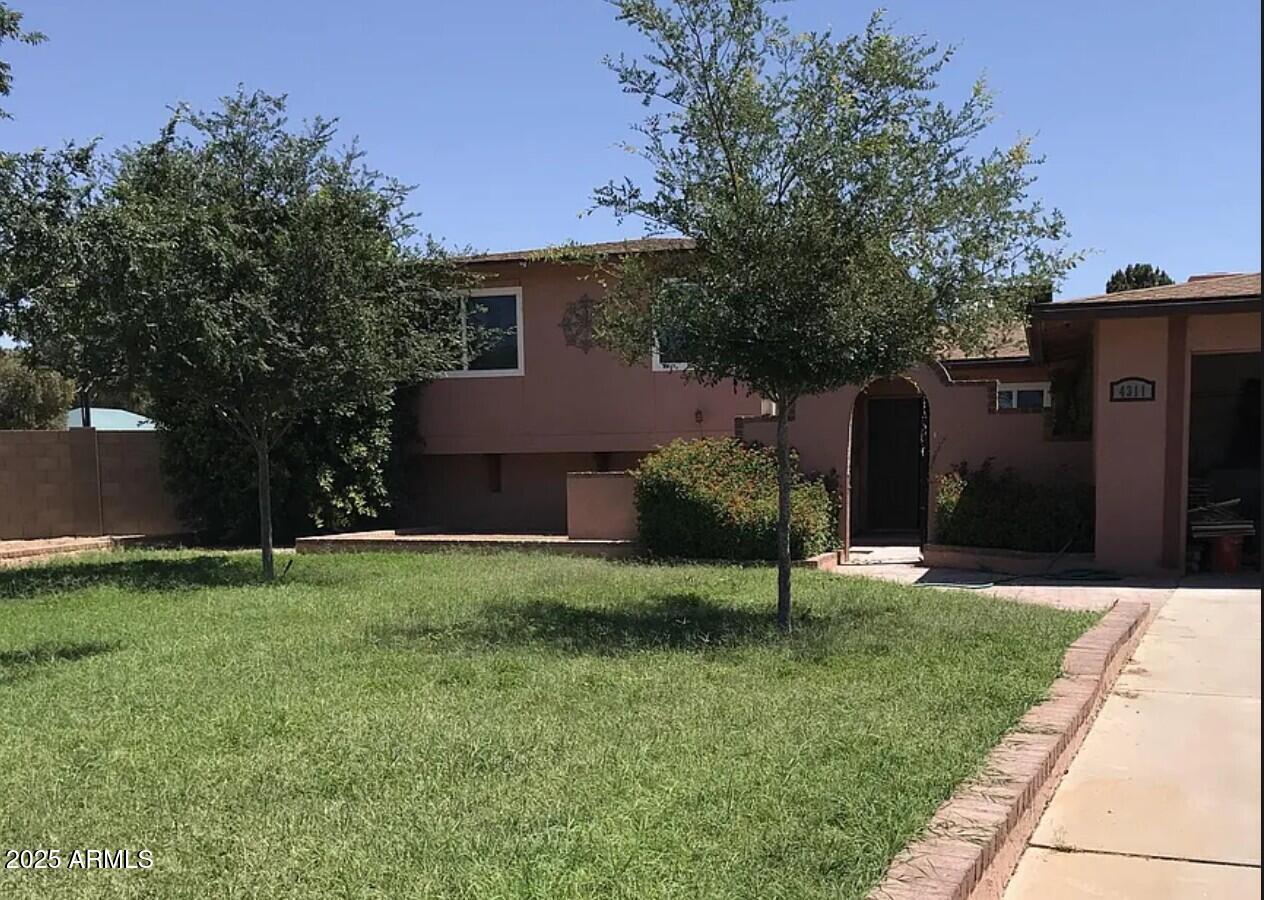 a house view with a sitting space and garden