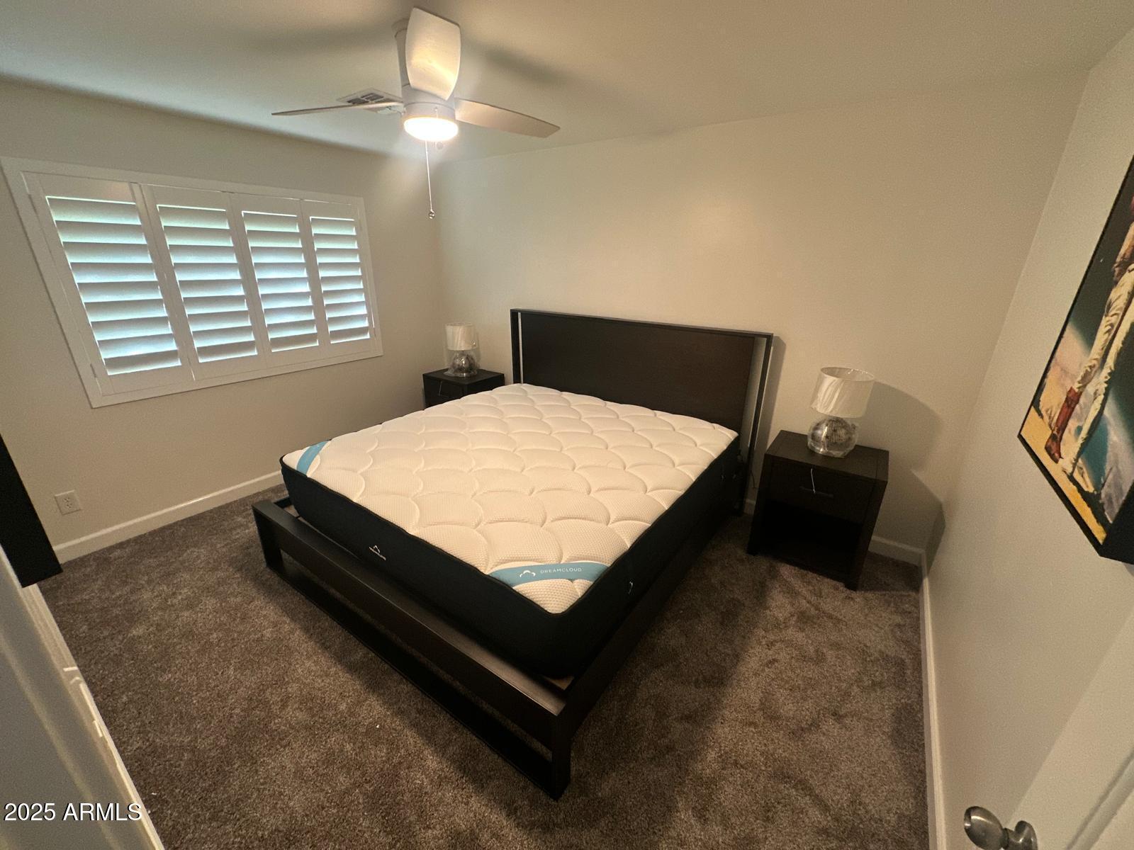 4311 West Sandra Circle Glendale, AZ 85308 - Photo 11 of 19 a bed sitting in a bedroom next to a window