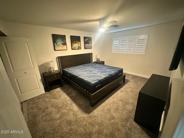 a bed sitting in a bedroom next to a window