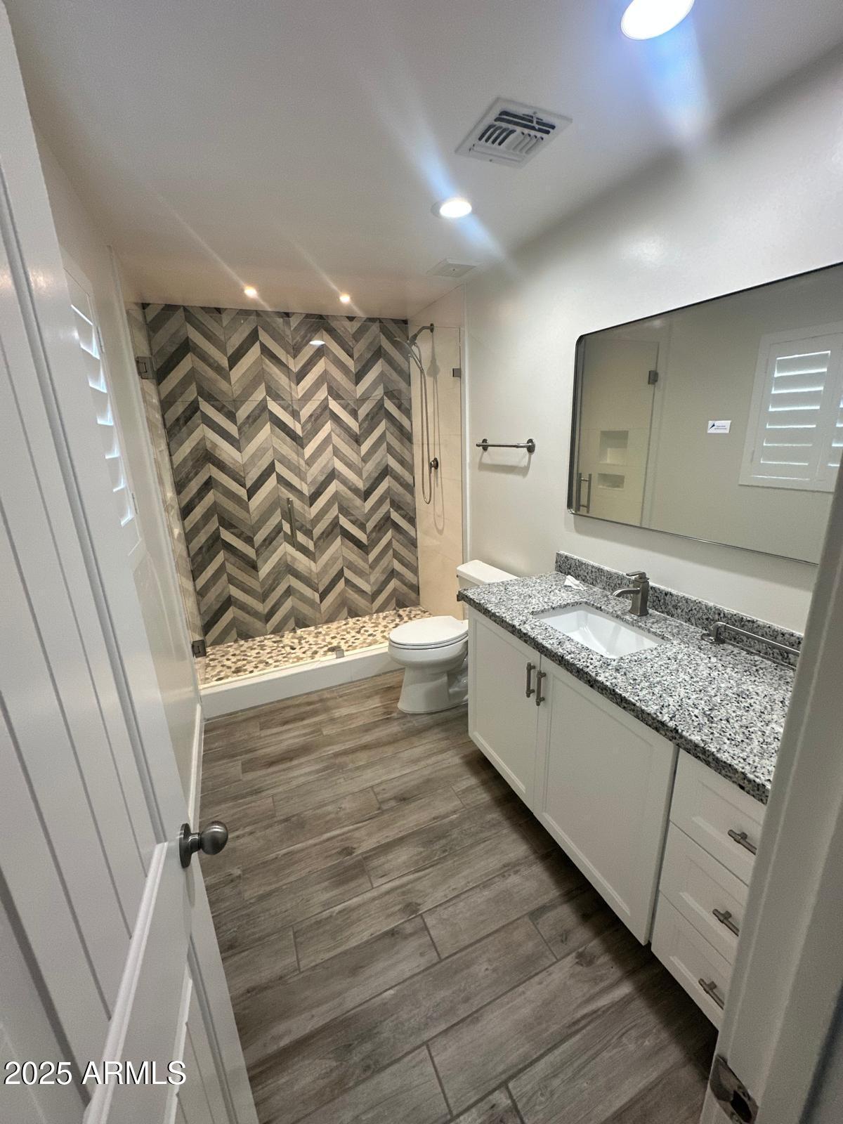 4311 West Sandra Circle Glendale, AZ 85308 - Photo 14 of 19 a bathroom with a granite countertop sink and a mirror