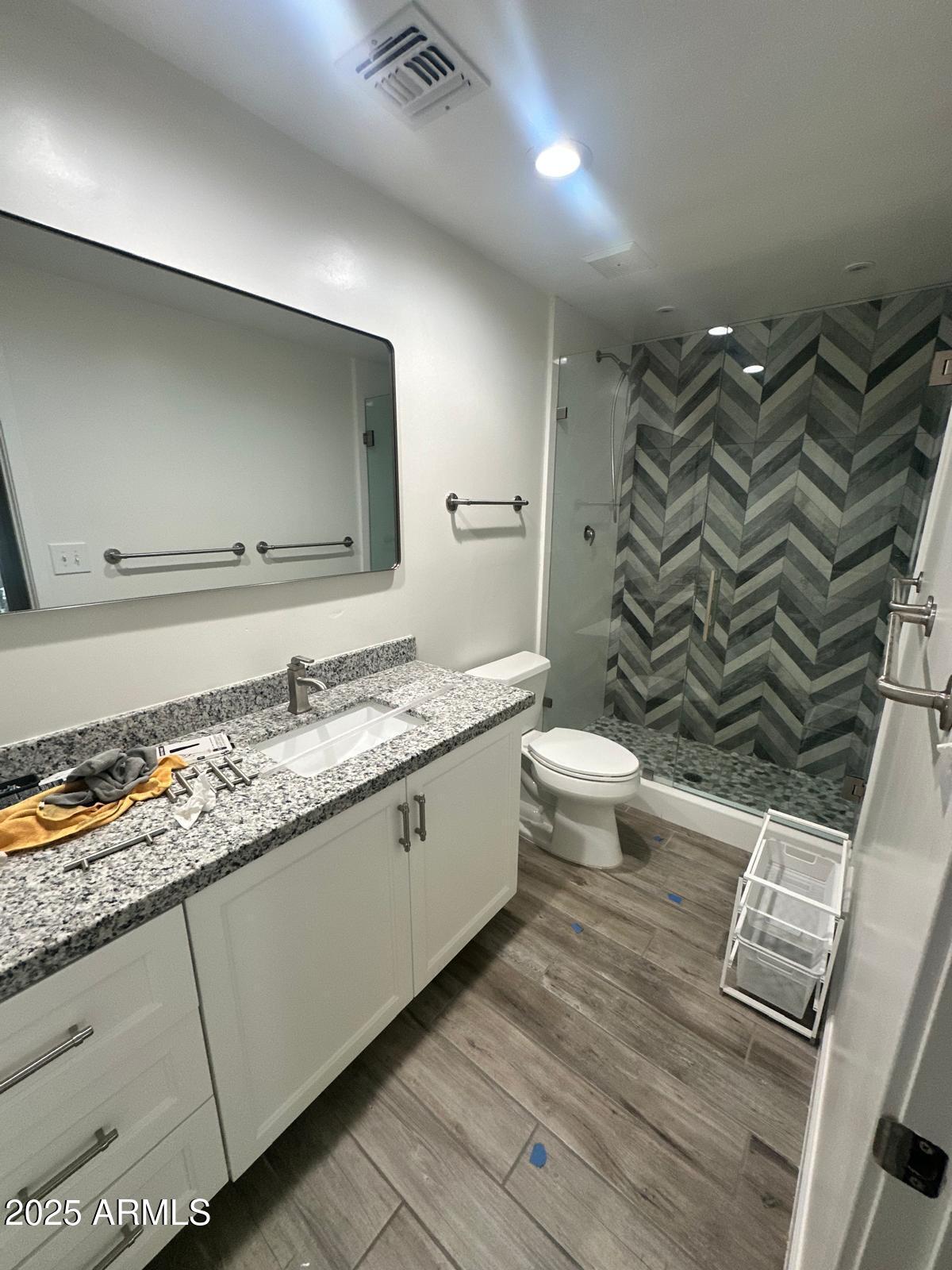 4311 West Sandra Circle Glendale, AZ 85308 - Photo 16 of 19 a bathroom with a granite countertop sink toilet and shower