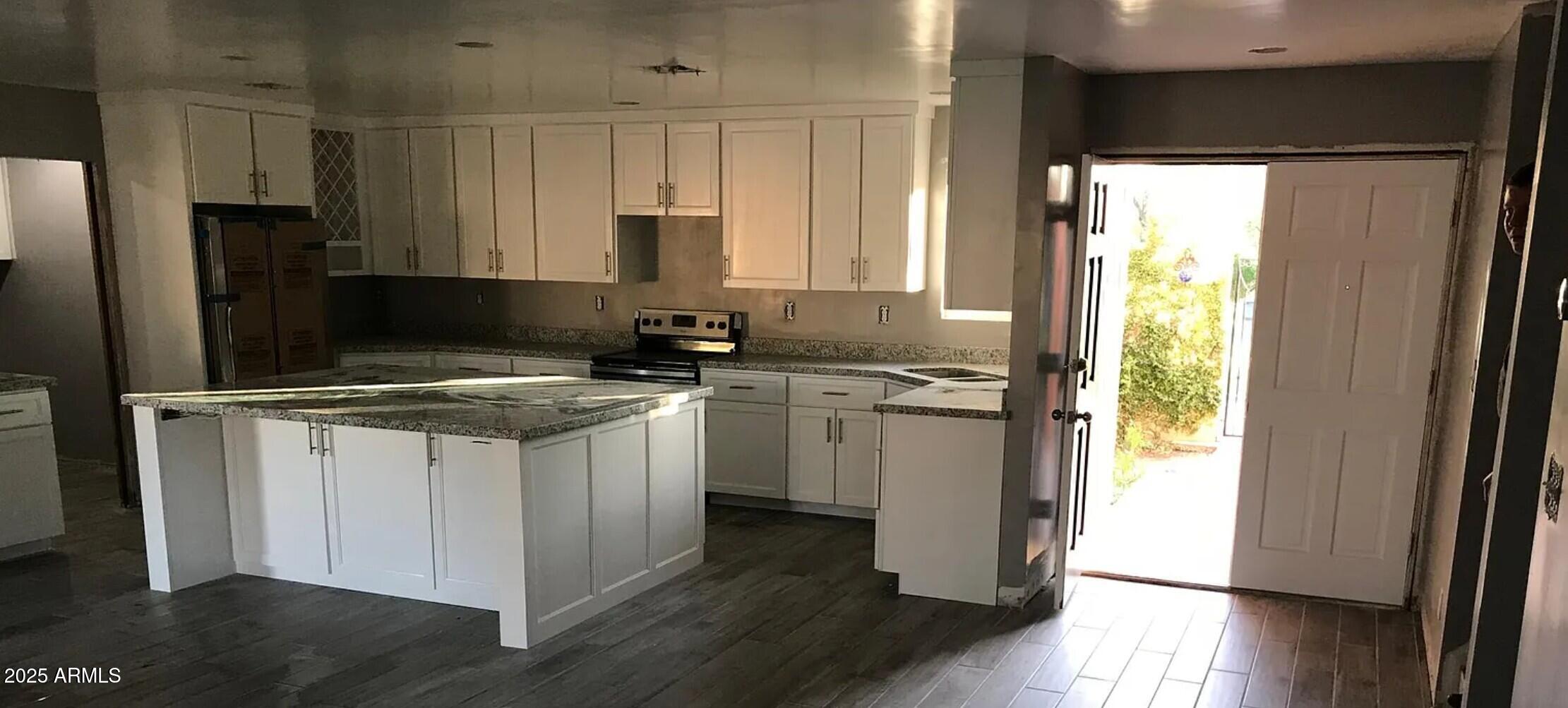 4311 West Sandra Circle Glendale, AZ 85308 - Photo 2 of 19 a kitchen with a sink stove and refrigerator