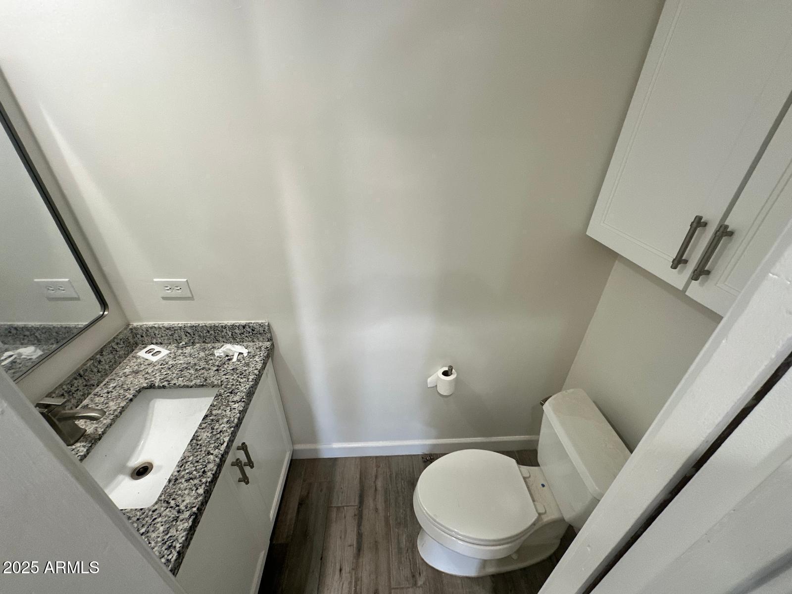4311 West Sandra Circle Glendale, AZ 85308 - Photo 5 of 19 a bathroom with a toilet a sink and mirror