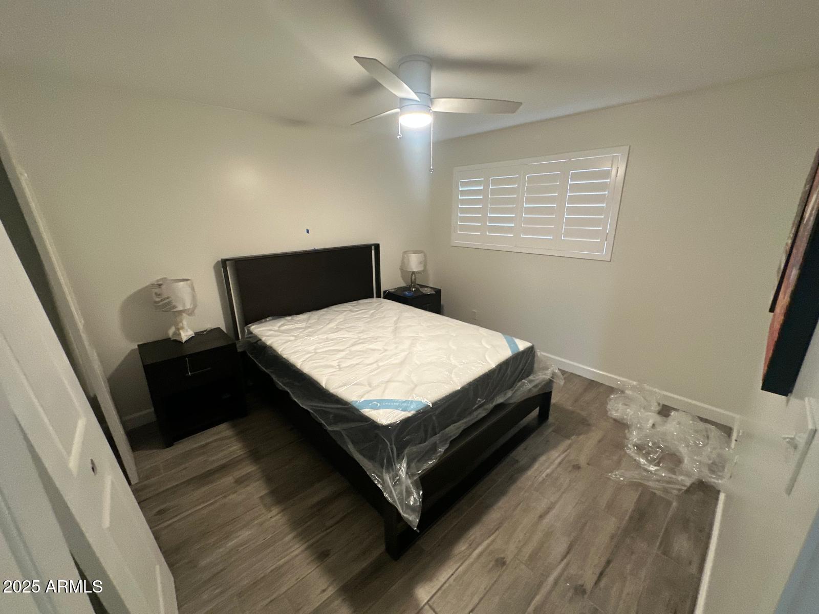 4311 West Sandra Circle Glendale, AZ 85308 - Photo 7 of 19 a bed sitting in a bedroom next to a window