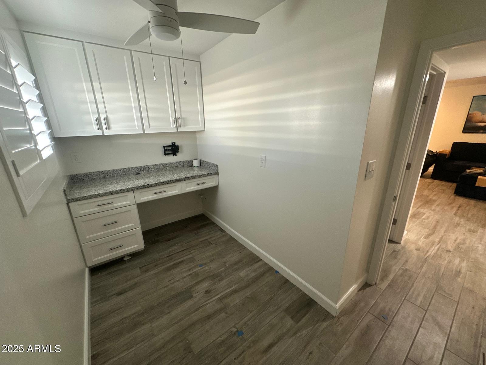 4311 West Sandra Circle Glendale, AZ 85308 - Photo 9 of 19 a room with wooden floor and white walls