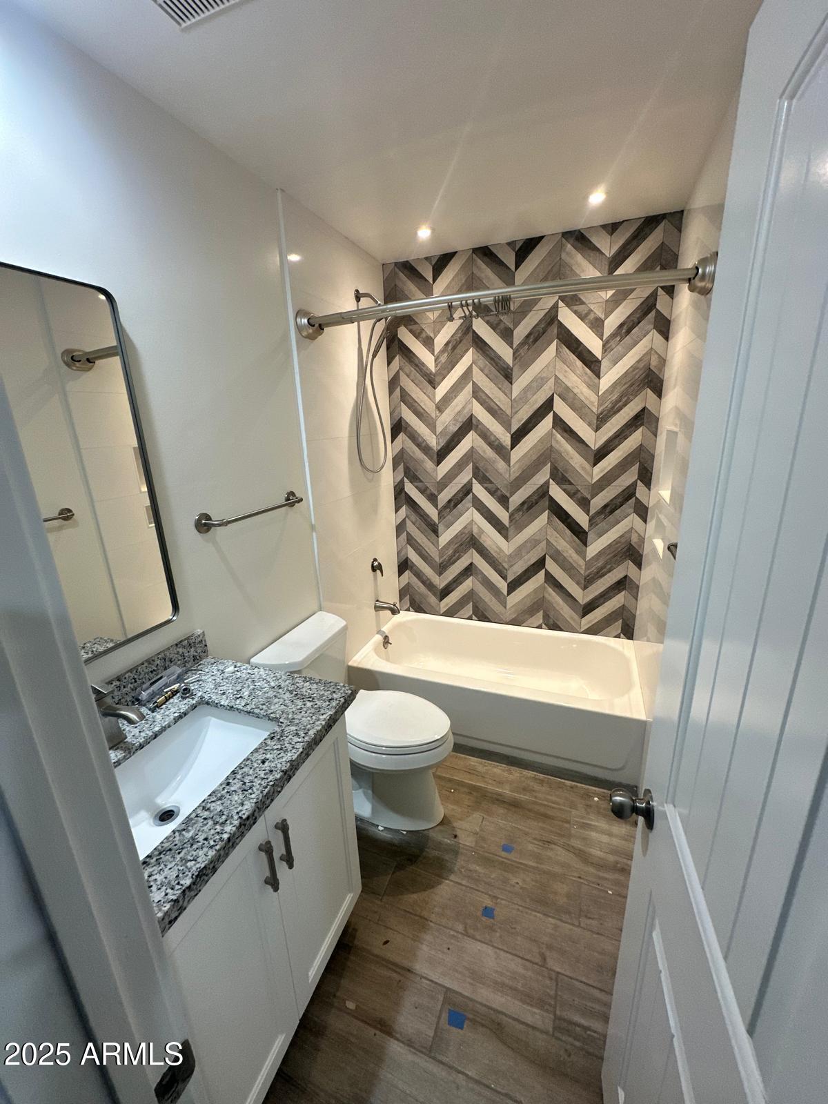 4311 West Sandra Circle Glendale, AZ 85308 - Photo 10 of 19 a bathroom with a granite countertop sink toilet and shower