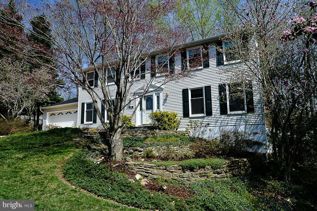 7824 Roundabout Way Springfield, VA 22153 - Photo 1 of 1 a front view of a house with a garden