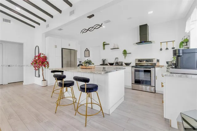 a kitchen with a sink cabinets and wooden floor