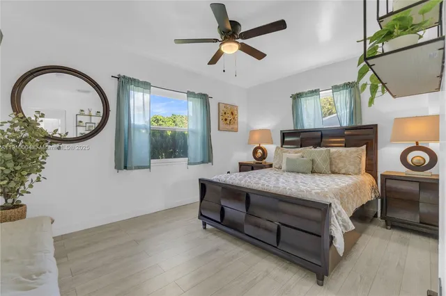 a spacious bedroom with a bed dresser and a window