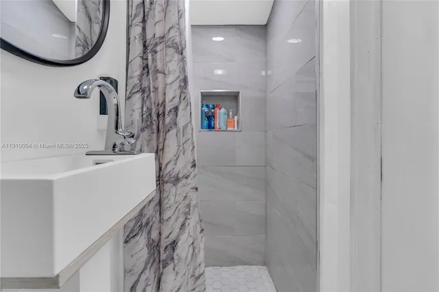 a bathroom with a sink and mirror