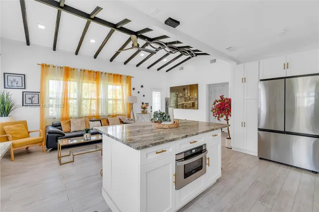 a kitchen with stainless steel appliances granite countertop a stove and a refrigerator