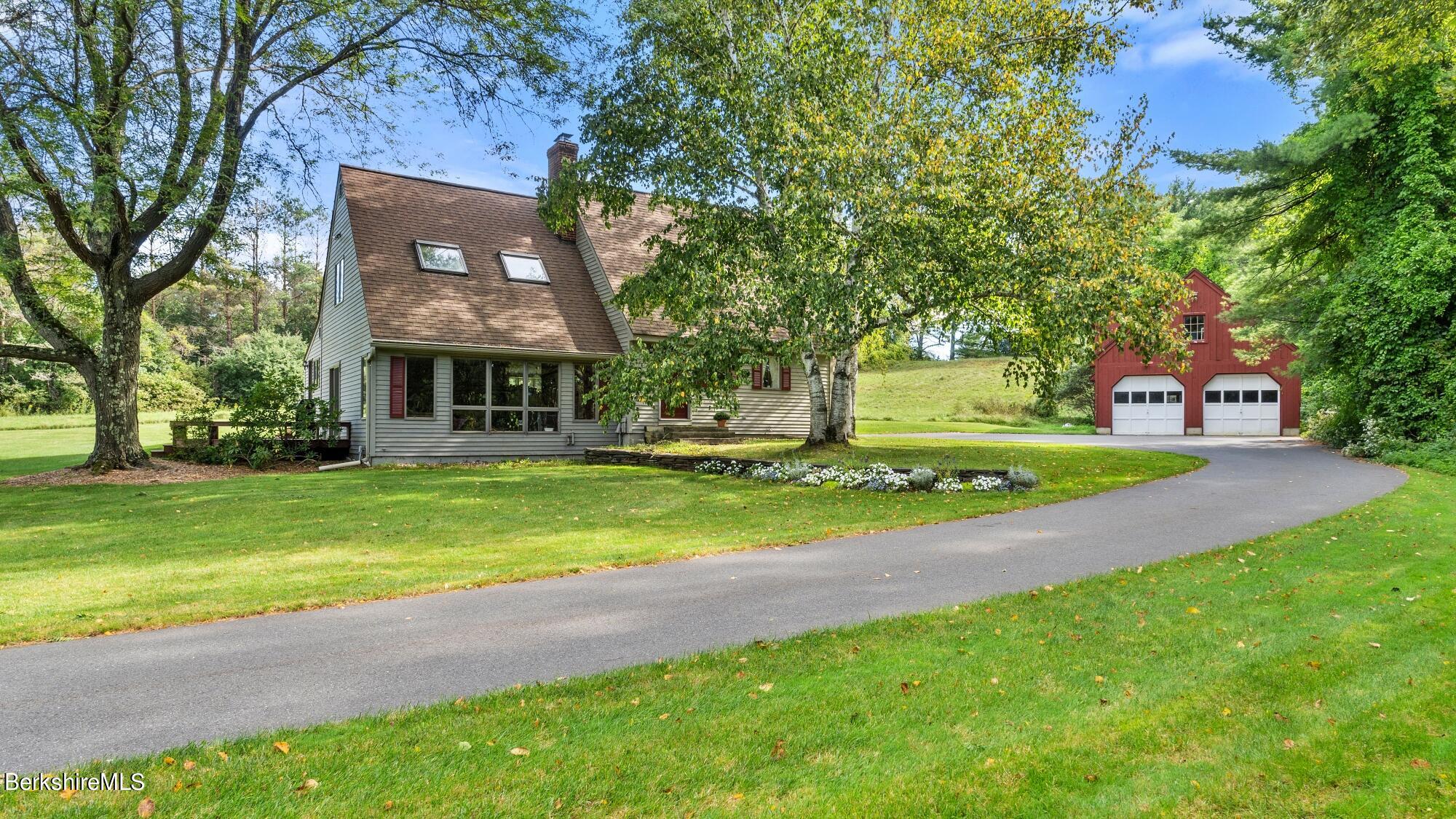 16 Interlaken Road Stockbridge, MA 01266 - Photo 1 of 42 a front view of a house with a yard and large trees