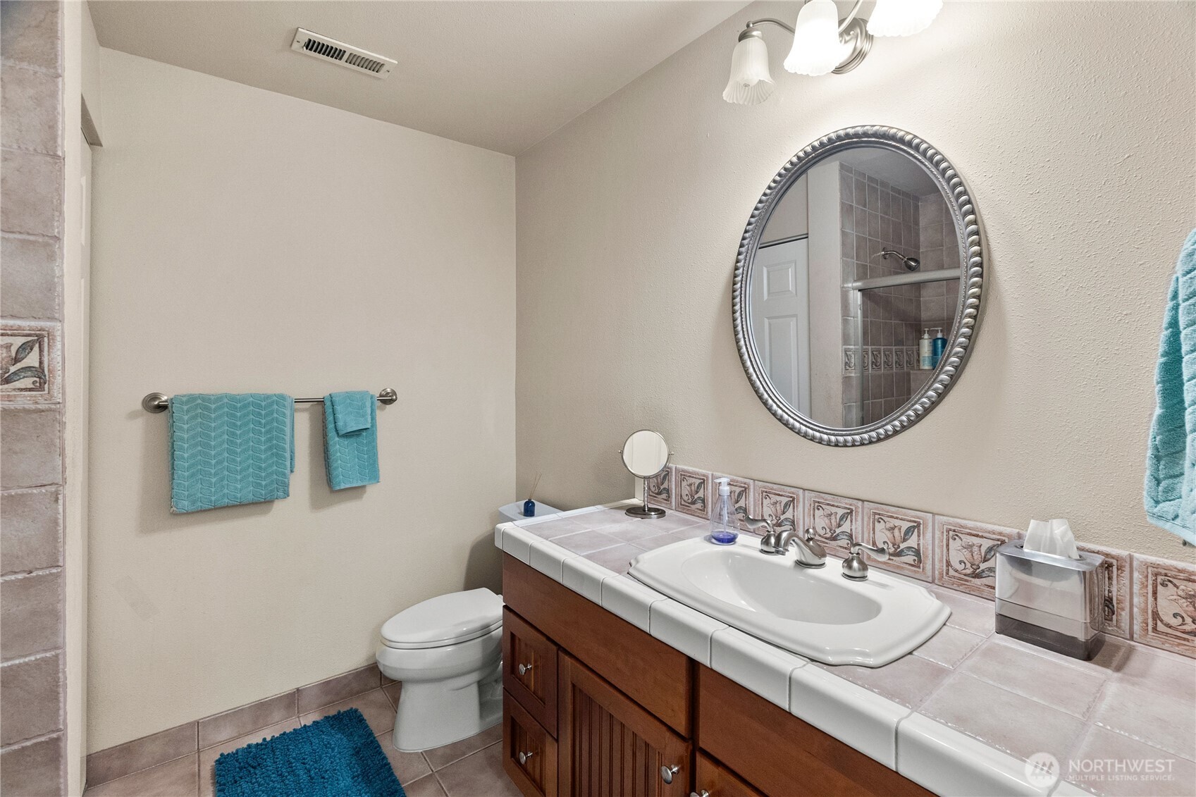 4346 Southwest 307th Street Federal Way, WA 98023 - Photo 22 of 40 a bathroom with a toilet a sink and a mirror