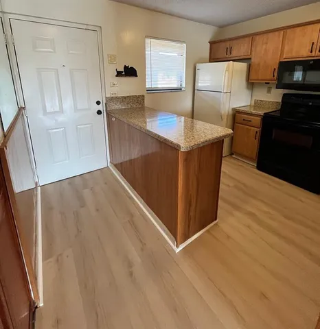 a kitchen with stainless steel appliances a refrigerator and a stove